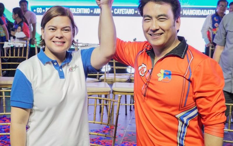 Sara Duterte raising the hand of Bong Revilla