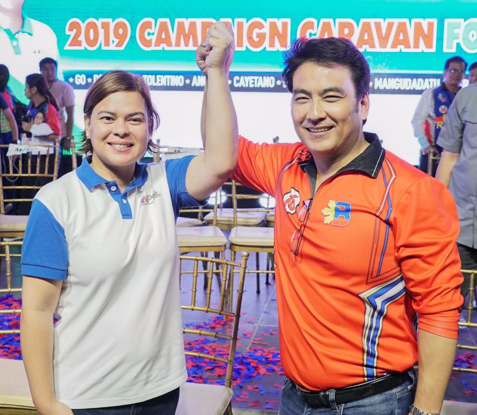 Sara Duterte raising the hand of Bong Revilla