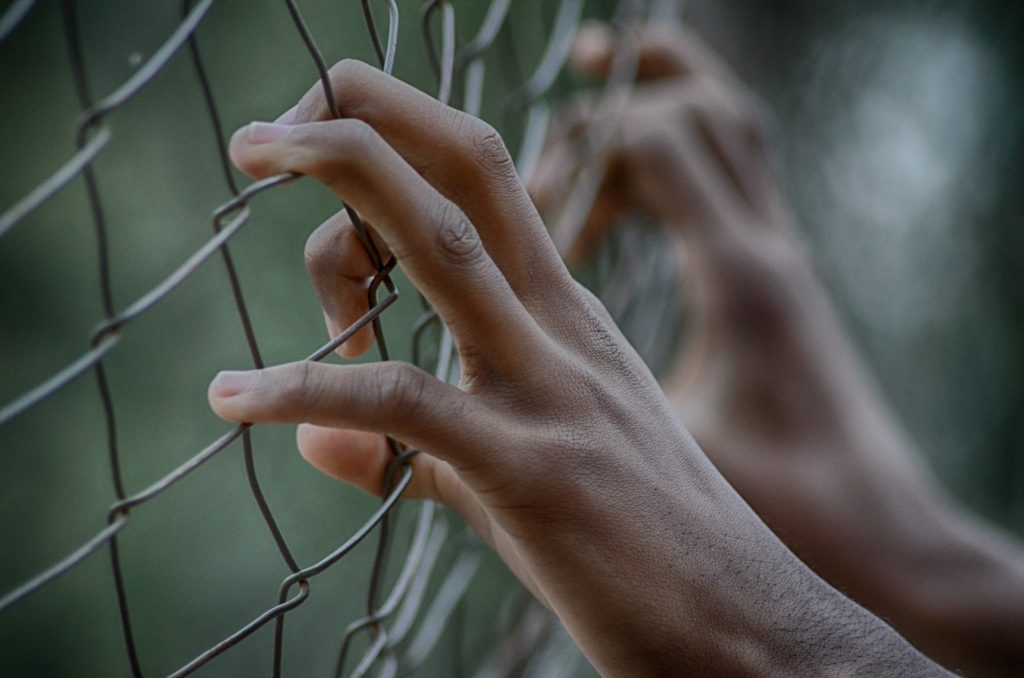 Stock photo of prisoner behind fence