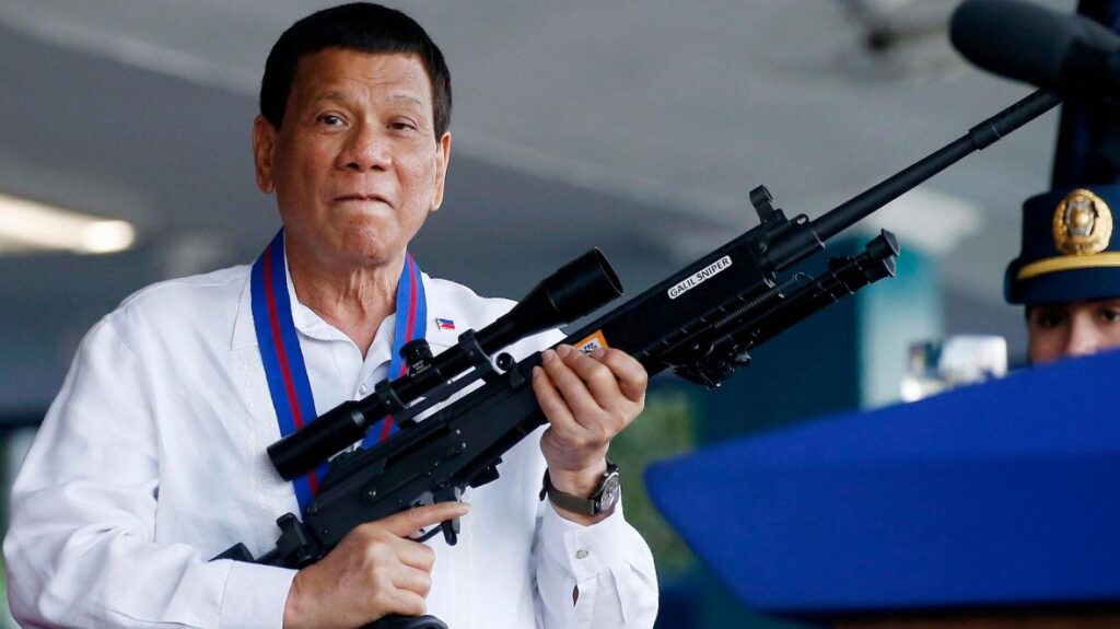 Rodrigo Duterte holding a firearm