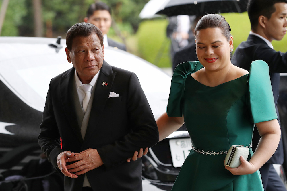 President Rodrigo Duterte walks his daughter and incumbent Davao City mayor Sara Duterte. [Photo: The Asashi Shimbun/Getty Images]