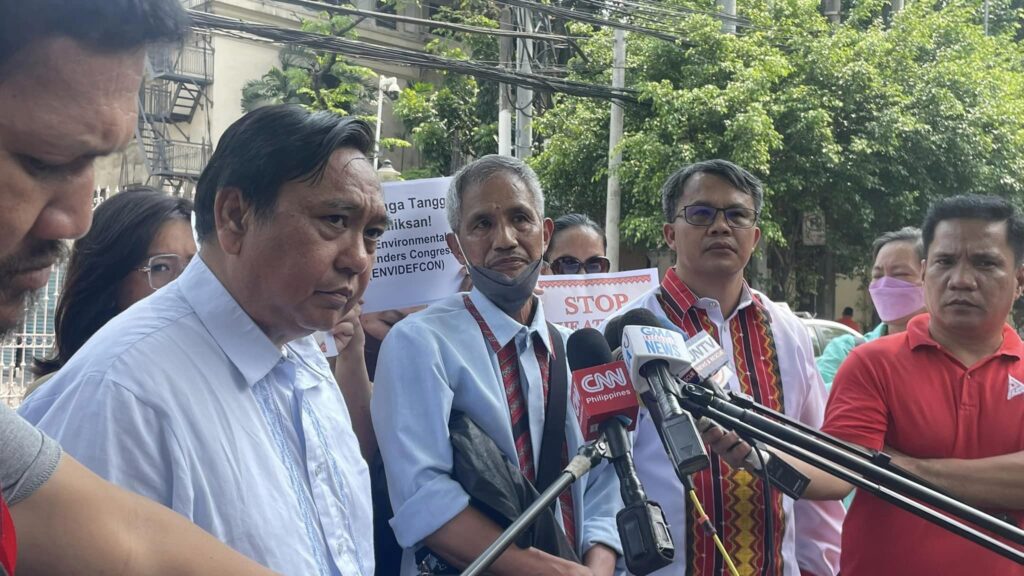 Windel Bolinget (second from right, in white and red) and Stephen Tauili (middle, in light blue and red) speak to the media after a filing a petition at the Supreme Court in June. (Photo: Cordillera Peoples Alliance/Facebook)